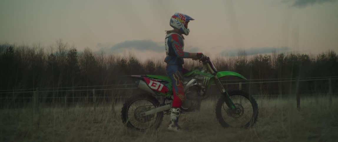 A man is sitting on his dirt bike