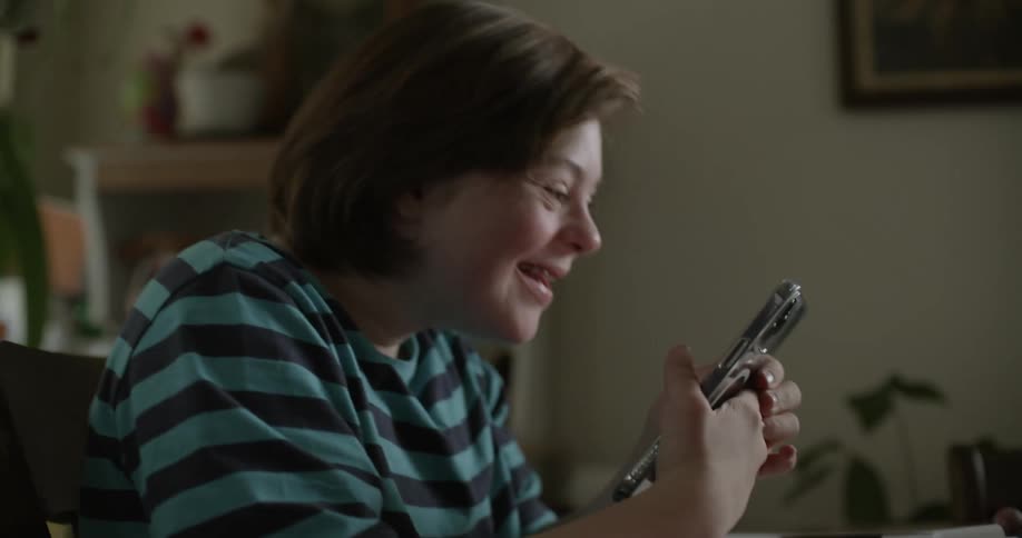 A person takes a selfie picture with their phone while having a video call