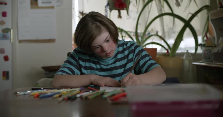 A girl is writing in her notebook on the table