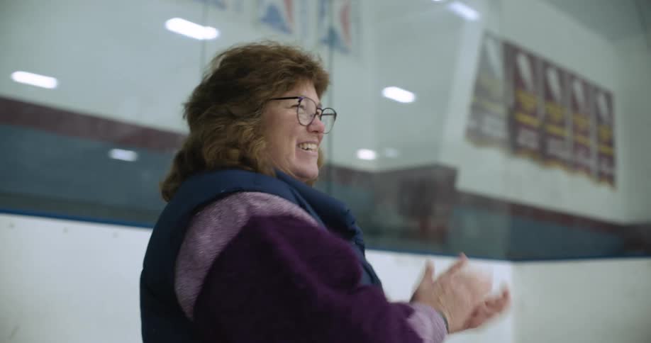 A woman clapping her hands and smiling