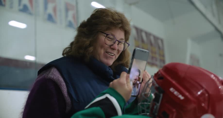 A girl puts a woman on video phone with her cell phone