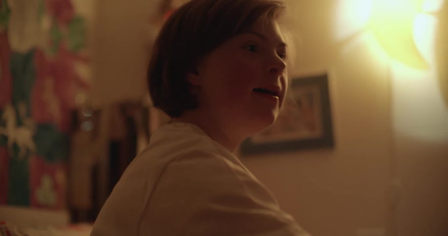 Teenage girl plays with dolls on her bed