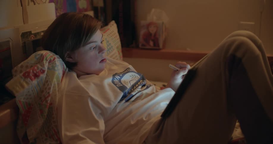 A girl is writing on her tablet