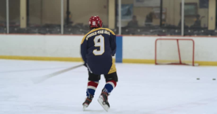 A hockey player takes a shot at a goal during practice
