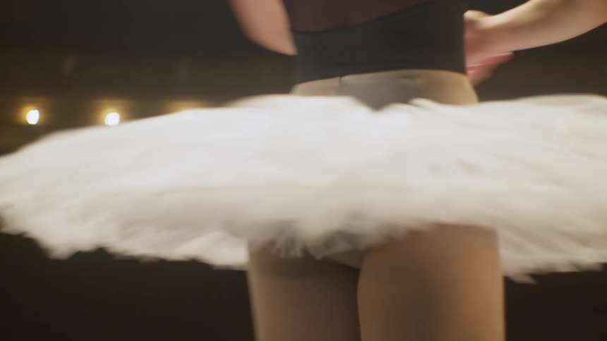 A woman is performing a ballet dance on a stage