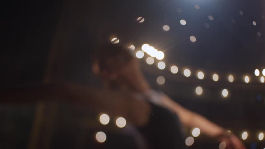A ballerina dances on a stage in a theater