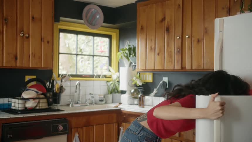 Person removing item from fridge