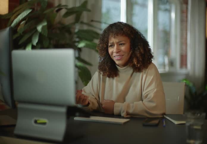 A woman uses her laptop for a video call