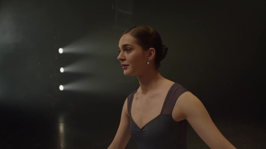 Ballet dancer complete dance on stage then smiles