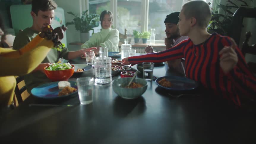 People sitting at the dinner table serve themselves