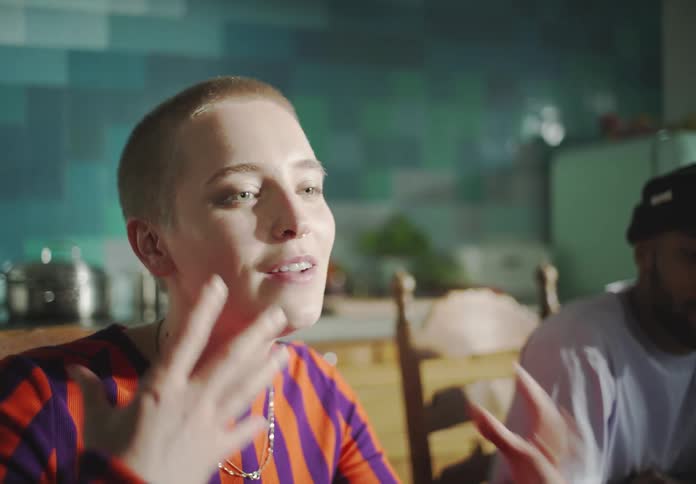 A woman eats and talks at the table
