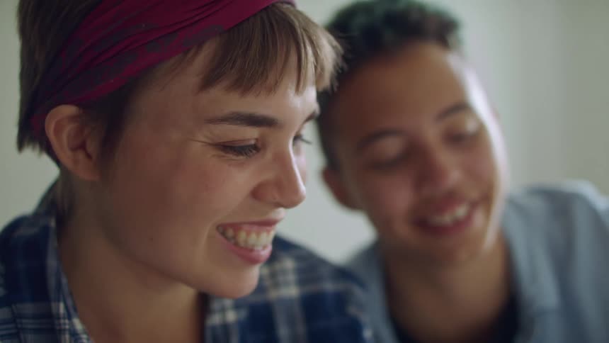 Two people talk together inside
