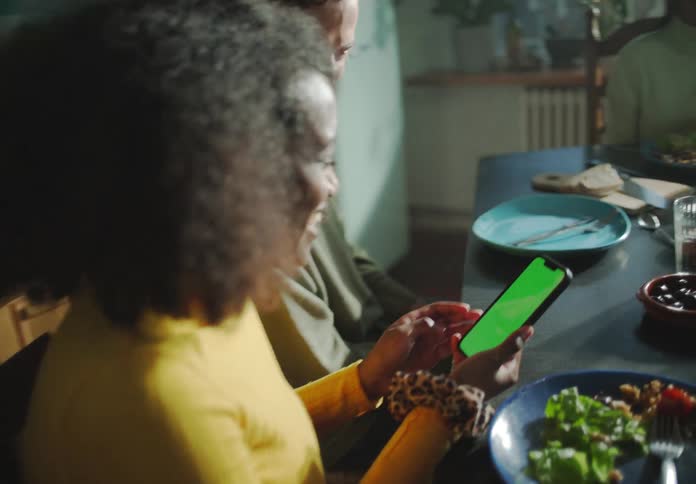 A man and woman laugh and talk at the dinner table