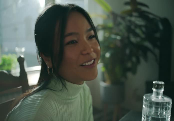 A woman is sitting and laughing and talking