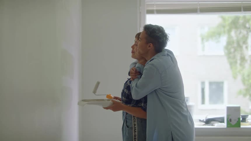 Female painting wall