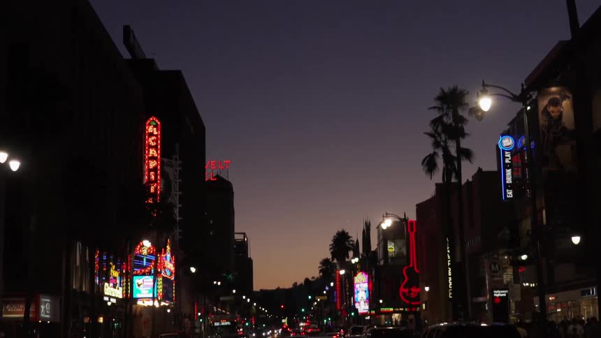 A stop light in a city at night