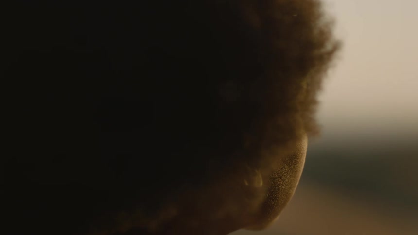 Close-up of black woman watching sunset