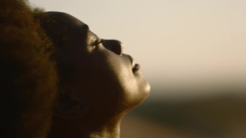 A woman enjoys the wind on her face
