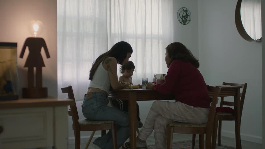 Family sits around table talking