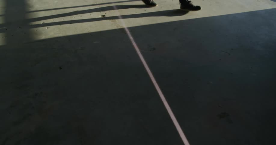 A person walks across the concrete