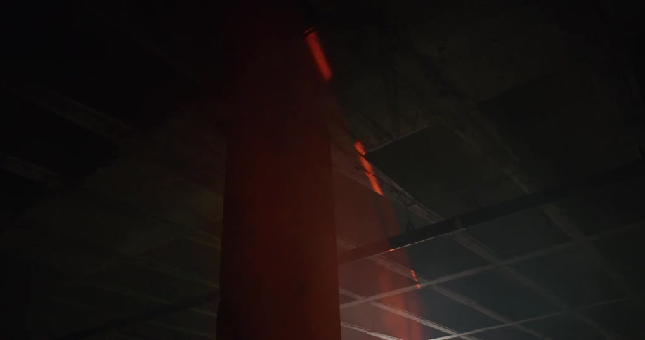 Red laser light scanning the roof and columns inside a dimly lit room