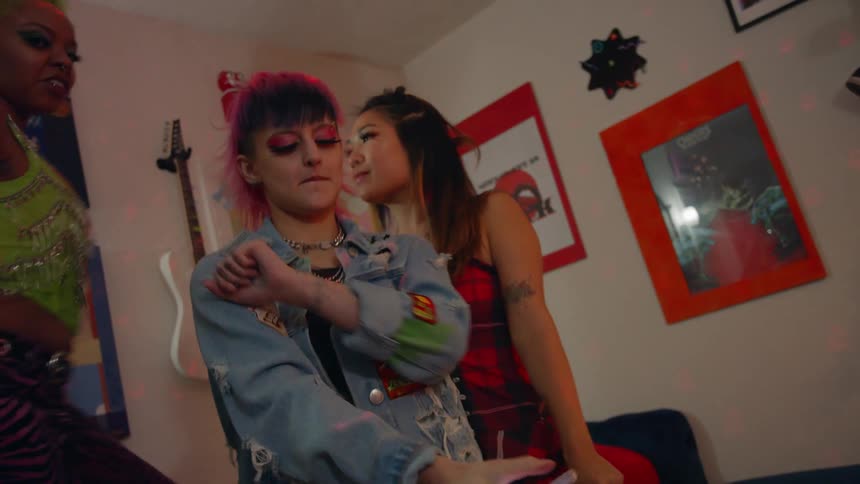 Group of happy friends dancing and taking selfies in the bedroom
