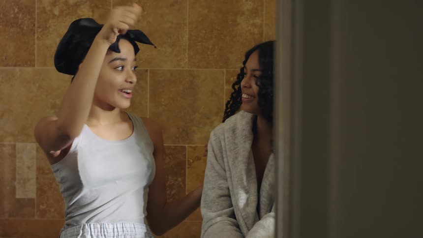 Two girls are talking to each other and laughing