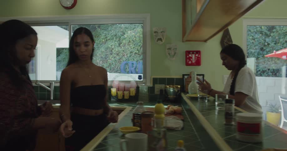 Group of women hanging out in the kitchen near the porch at home