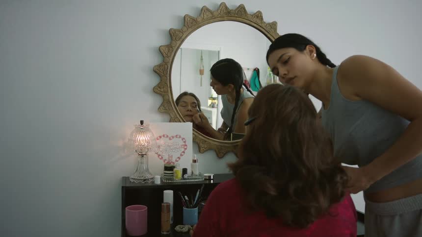 Daughter helps mother apply makeup