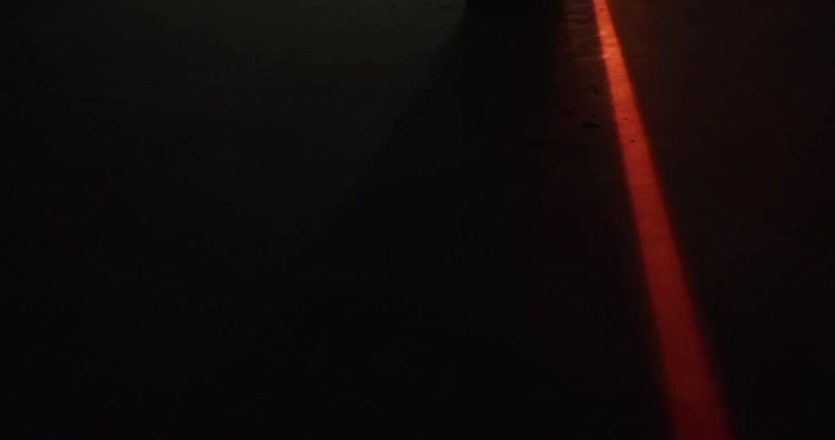 A red beam from a laser shines over a surface