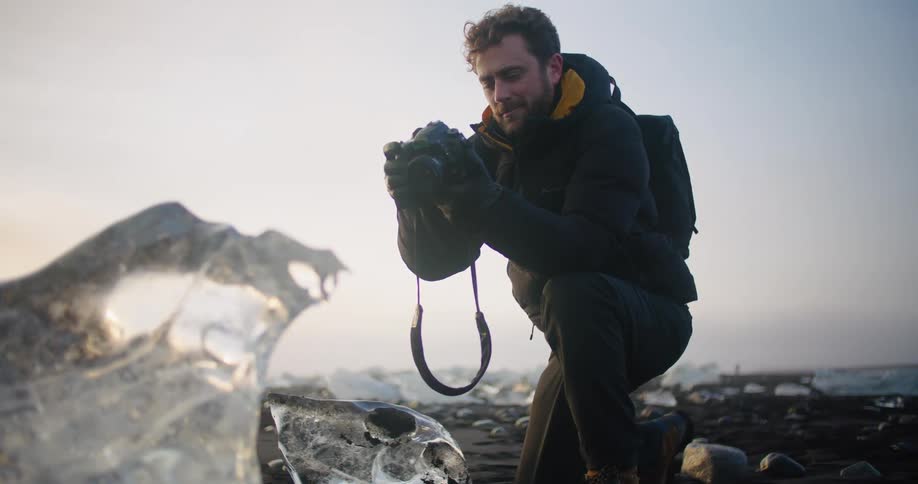 A man is taking pictures of nature on the beach
