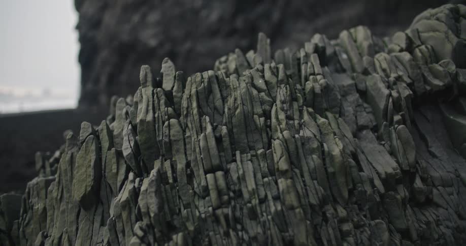 Rock formation on the reynisfjara black sand beach at sunset