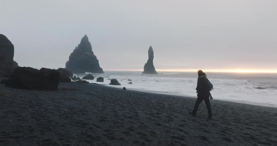 A man is hiking on the beach