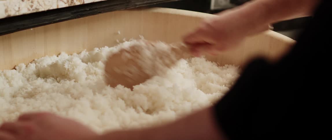 A person is cooking rice at their house