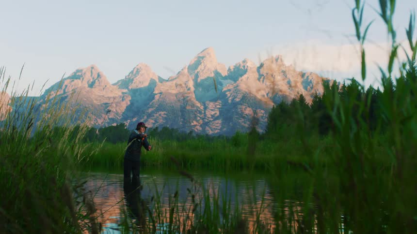A man is fly fishing in the water