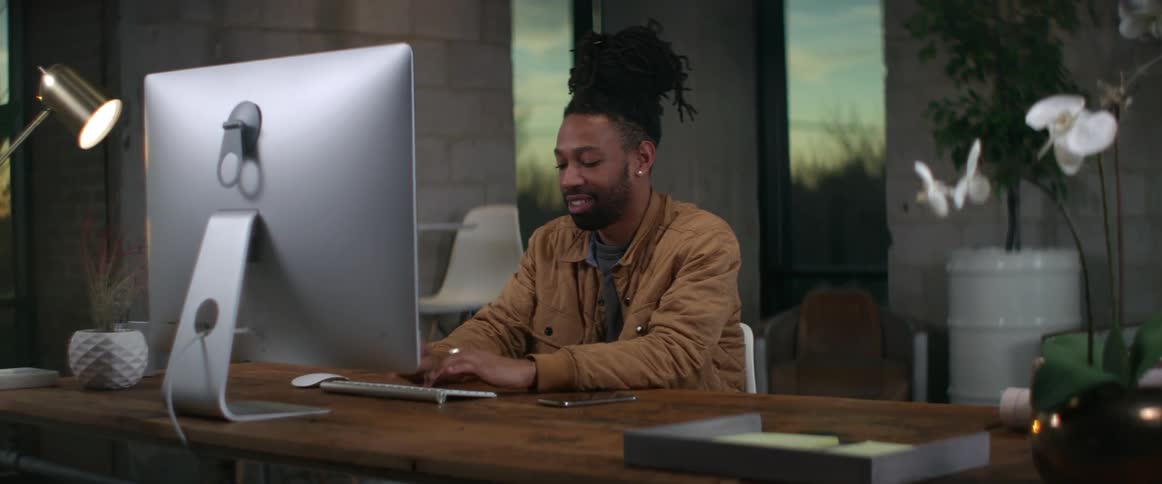 A man is typing at his desk