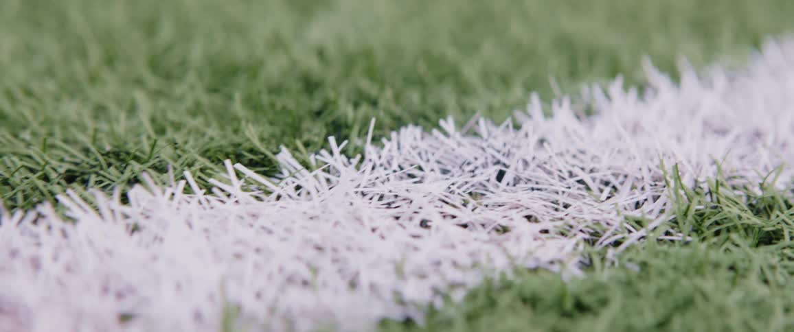 A white line painted in the grass of an athletic field
