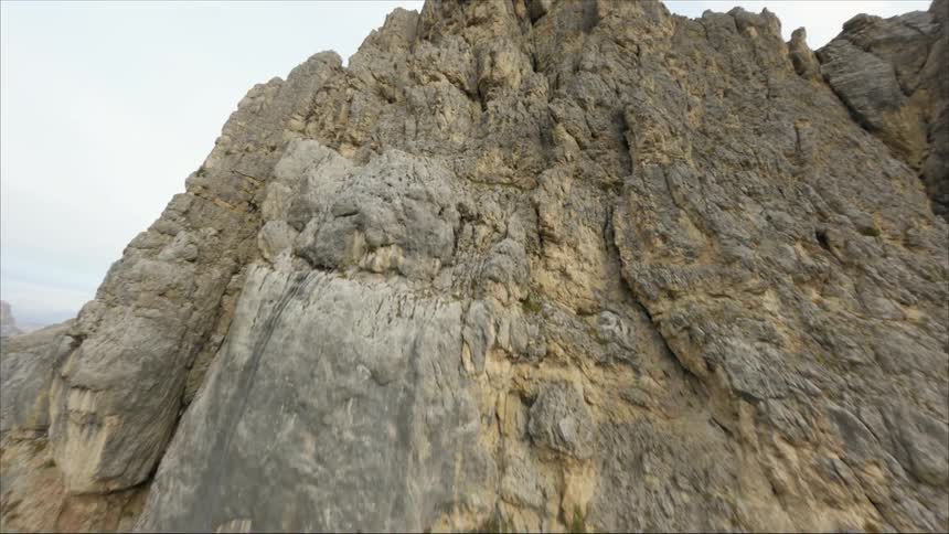 The peak of a giant rock crag in the wilderness on a cloudy day