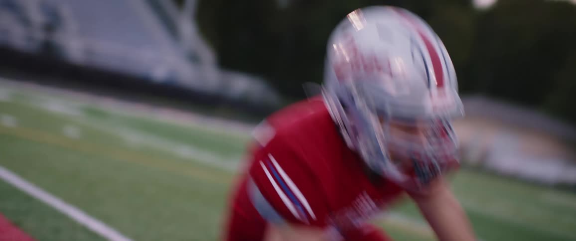 A football player is charging back and forth on the field