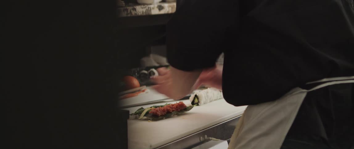 A chef preparing a meal on a restaurant kitchen countertop