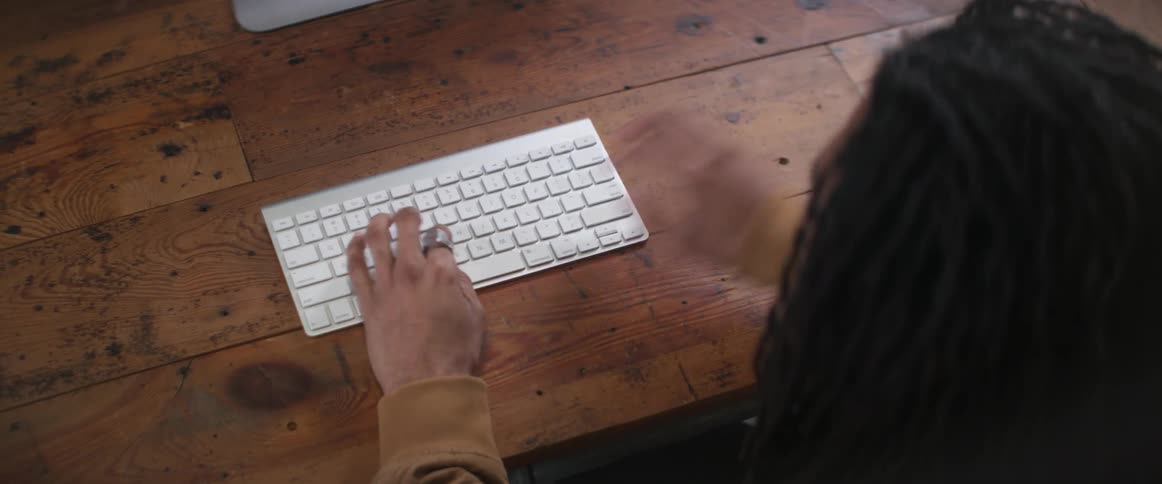 A man is typing on his keyboard