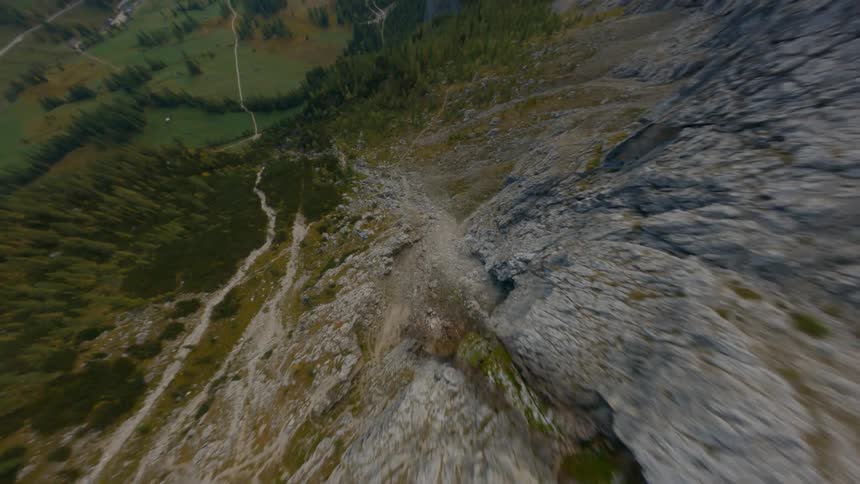 An aerial view of rocky cliffs and mountains surrounding a valley