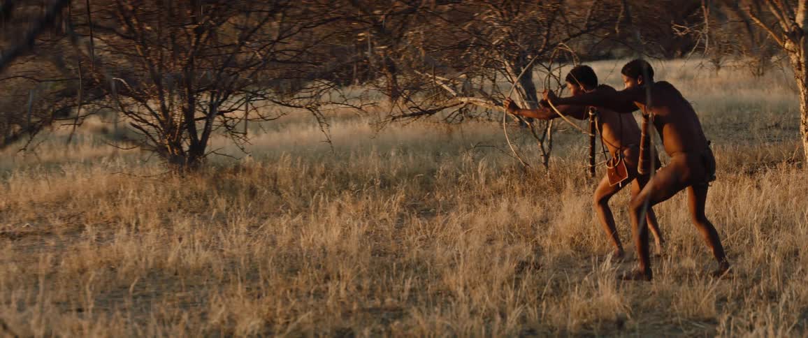 Two indigenous people hunting in savannah