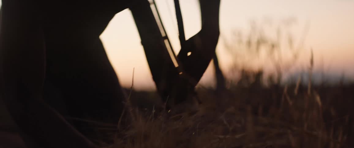 Tribal man gathers dried grass