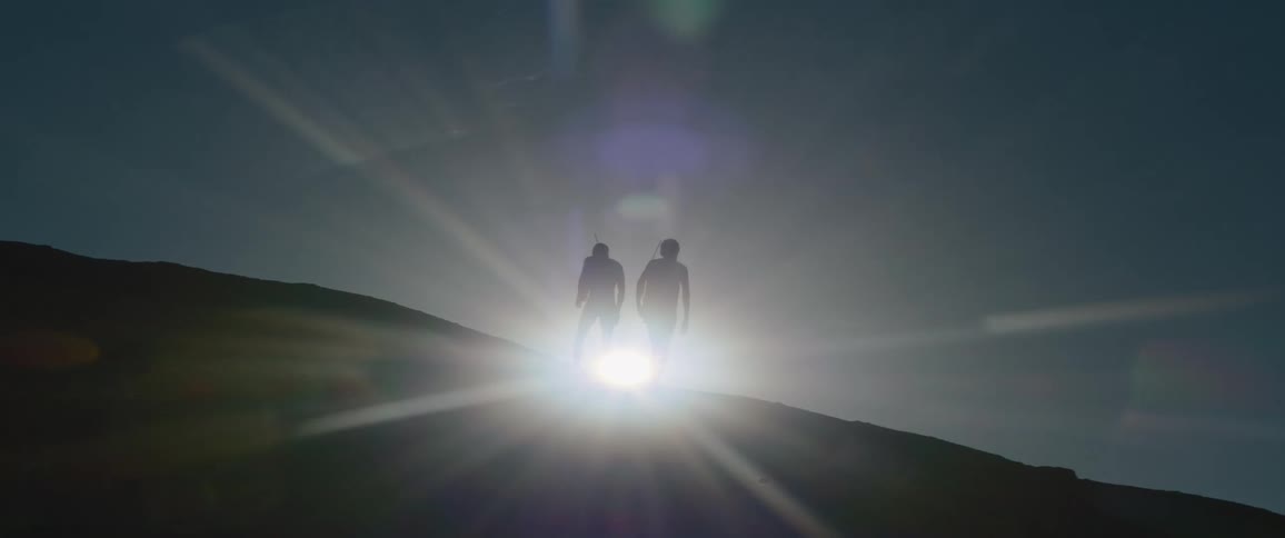 Silhouette's of tribal men on mountain