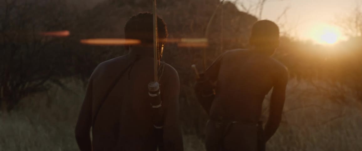 Indigenous men stalking prey at sunset
