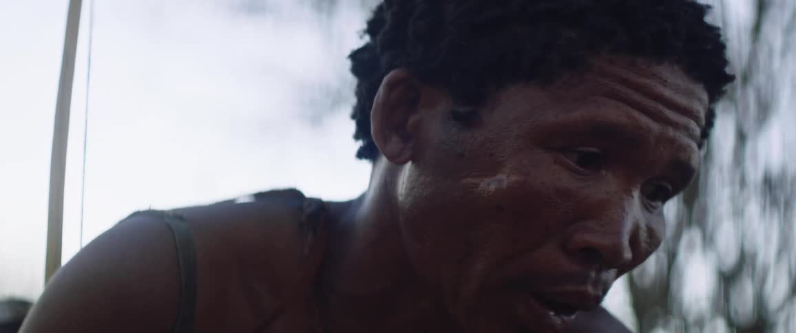 Two tribal men stalking prey