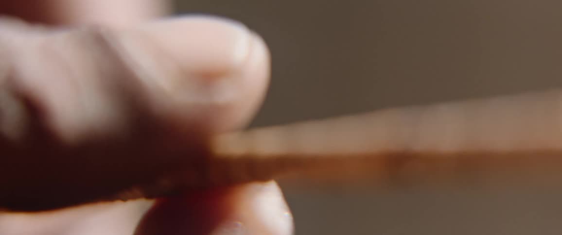 Close up of hands making arrow for hunting