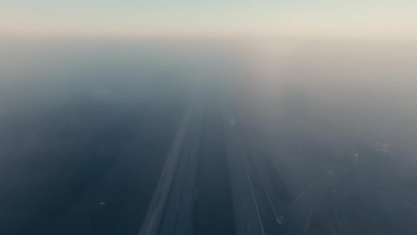 An aerial view of vehicles driving down highway