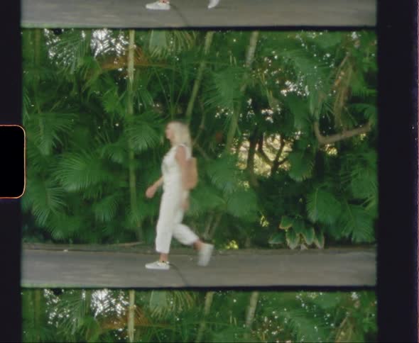 A woman is walking on a sidewalk in spring